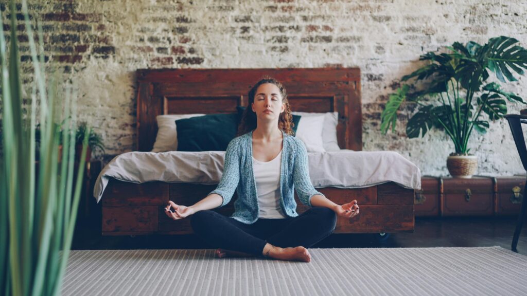 Person in a reflecting pose with eye close practicing being present. 